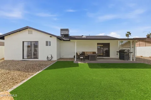 a view of a house with backyard porch and sitting area