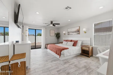 a spacious bedroom with a bed window and couch