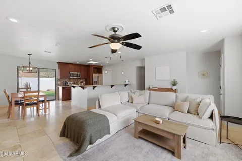 a living room with furniture and a chandelier