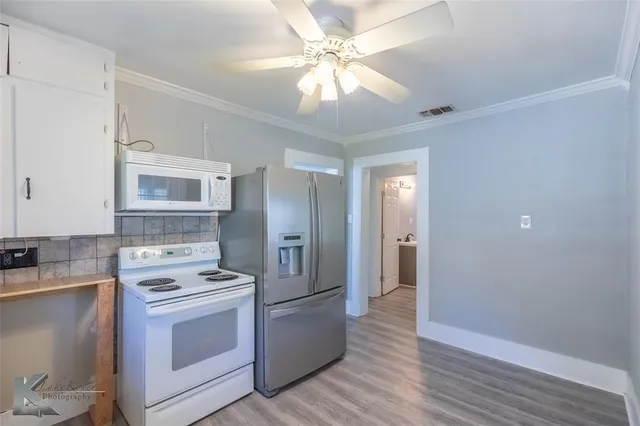 a kitchen with a stove refrigerator and a sink