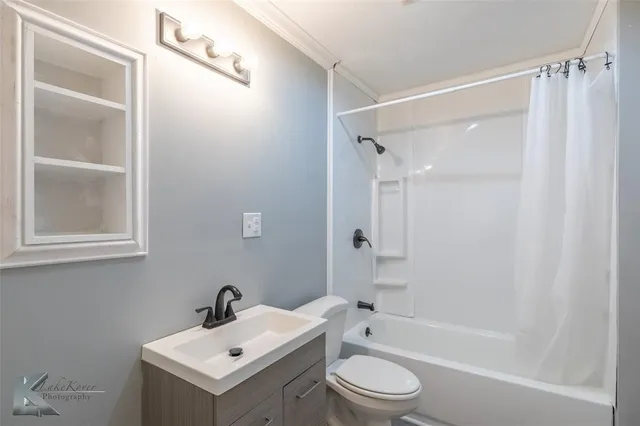 a bathroom with a sink mirror toilet and bathtub