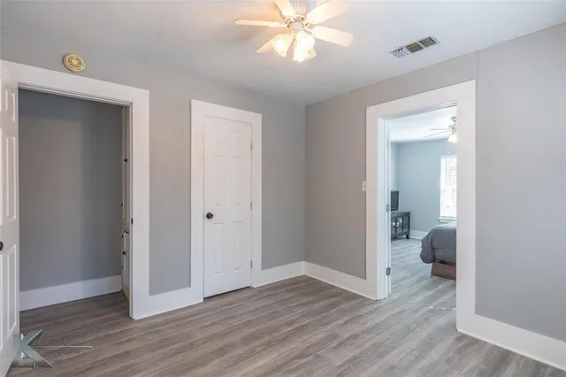 a view of hallway with wooden floor