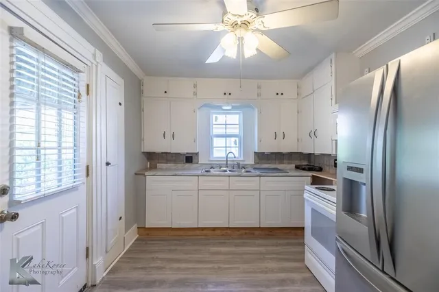 a kitchen with stainless steel appliances a sink stove and refrigerator