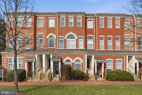 front view of a brick house with a yard