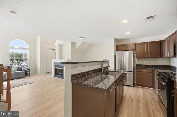 a kitchen with a center island and stainless steel appliances