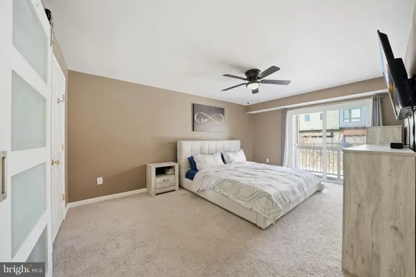 a spacious bedroom with a bed and a window