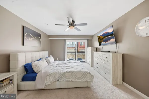 a bedroom with a bed dresser and wooden floor