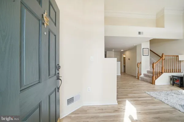 a view of a hallway with wooden floor and entryway