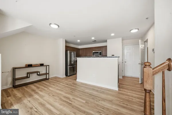 a view of kitchen with refrigerator microwave and furniture