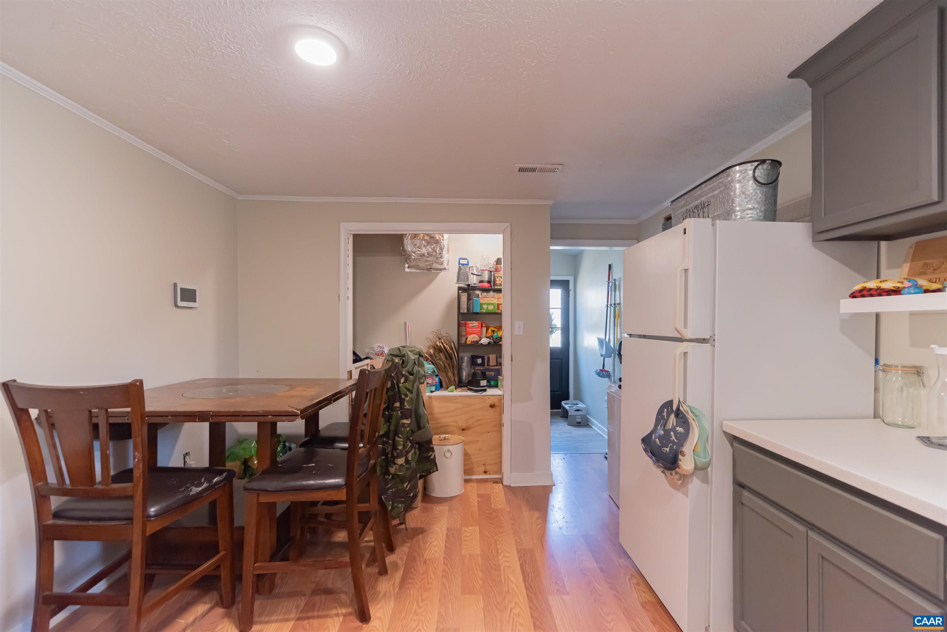 950 Apple Grove Road Mineral, VA 23117 - Photo 11 of 37 a kitchen with a refrigerator a dining table and chairs