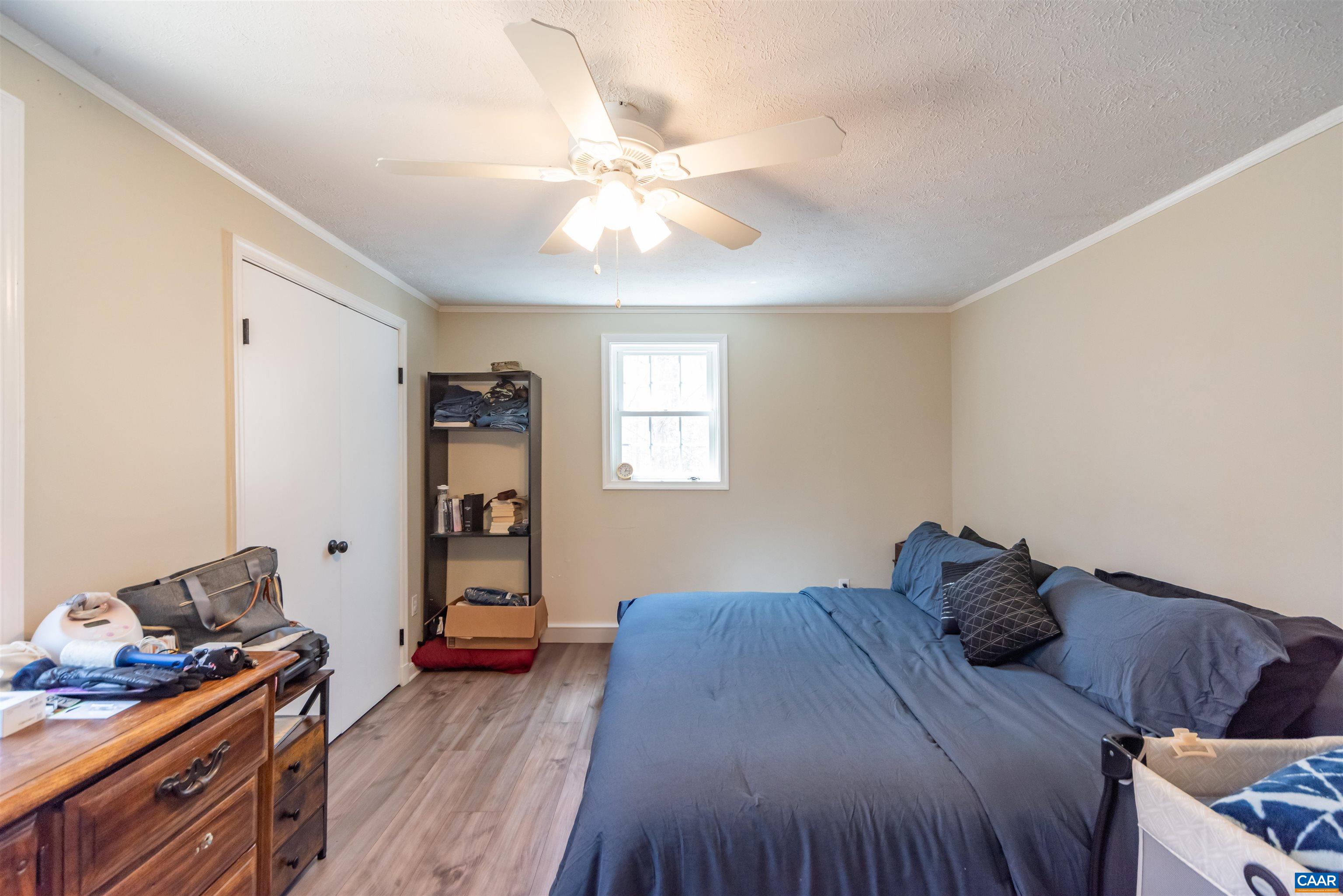 950 Apple Grove Road Mineral, VA 23117 - Photo 17 of 37 a bedroom with a bed and wooden floor