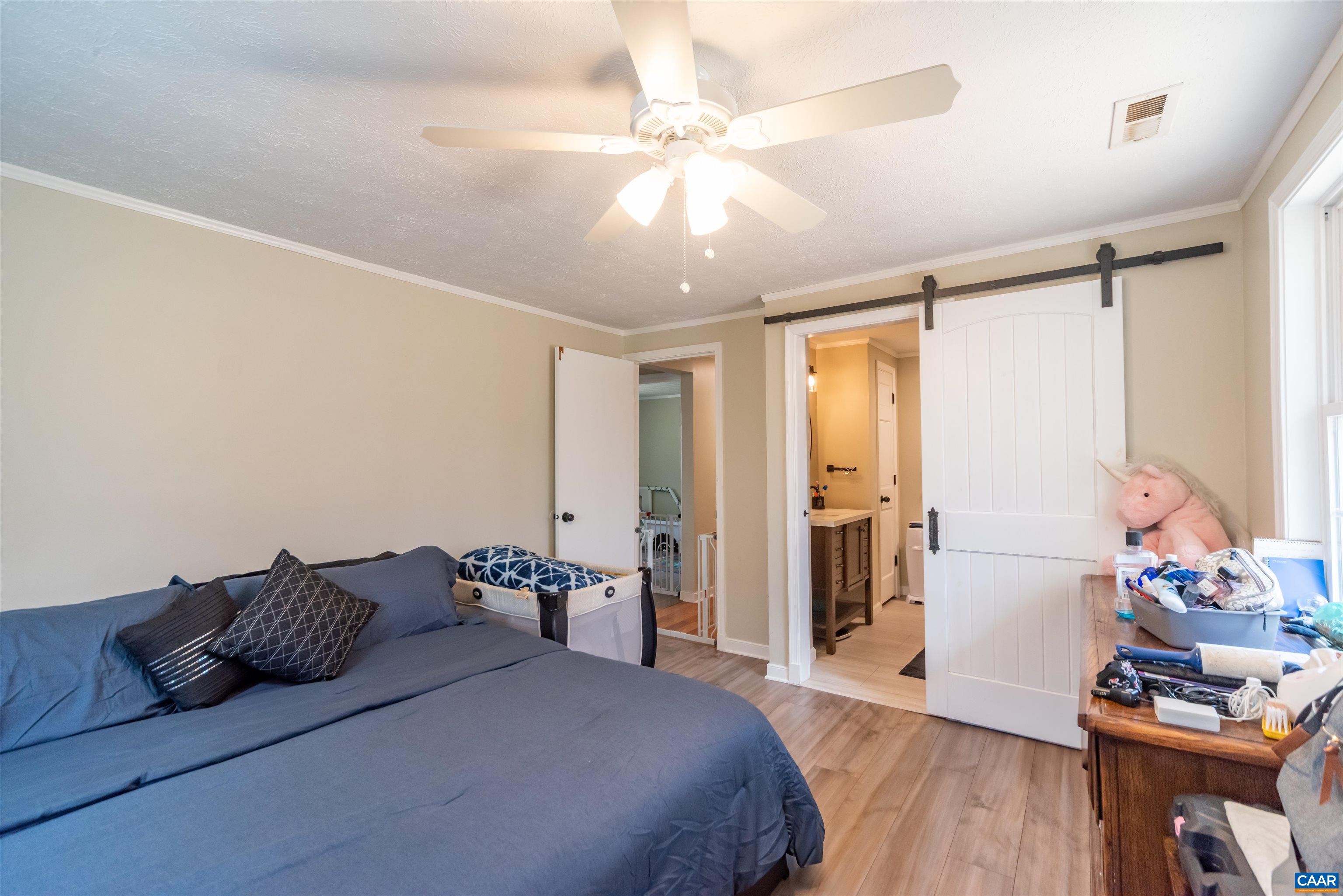 950 Apple Grove Road Mineral, VA 23117 - Photo 18 of 37 a bedroom with a bed and wooden floor
