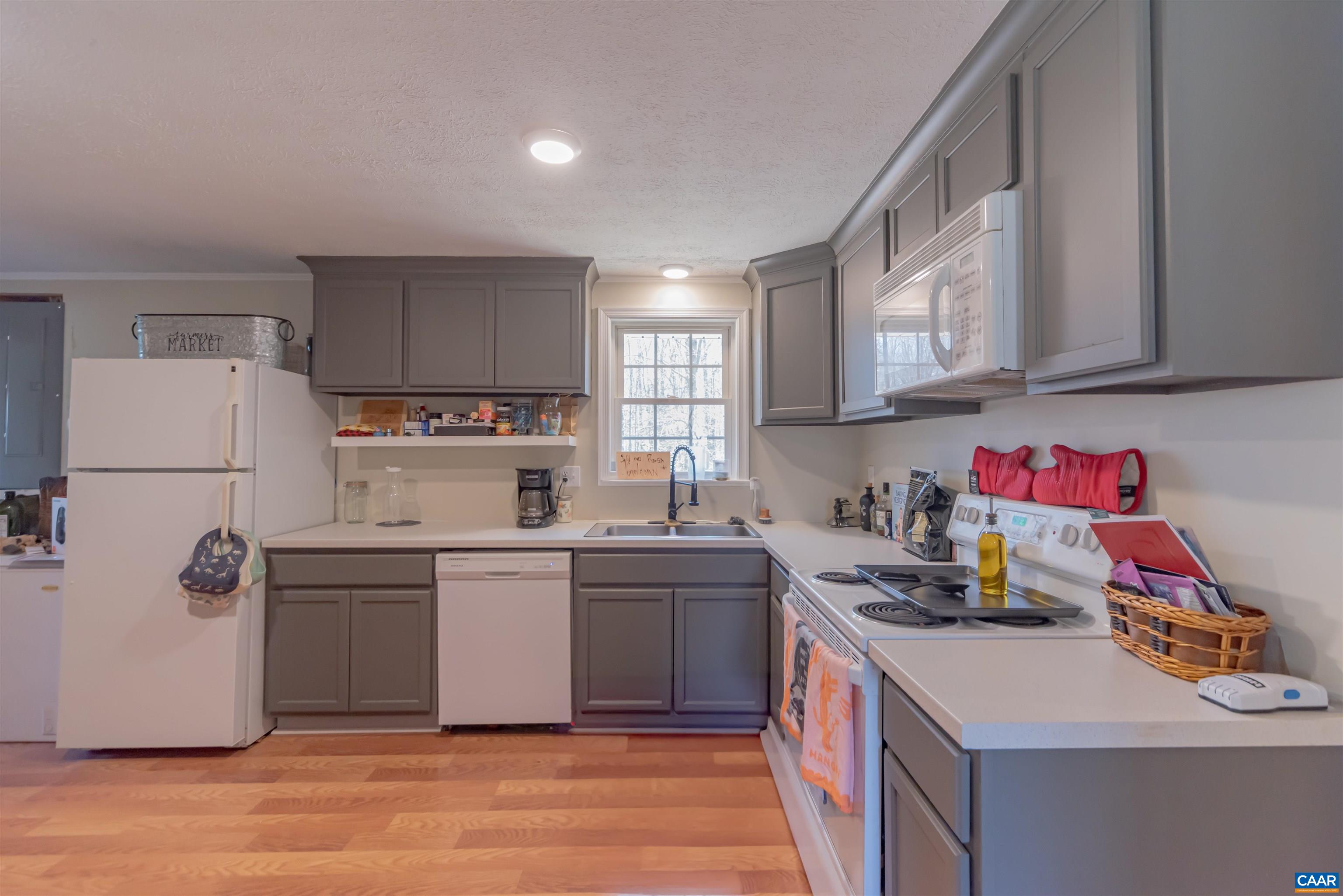 950 Apple Grove Road Mineral, VA 23117 - Photo 8 of 37 a kitchen with a sink a stove a refrigerator and cabinets