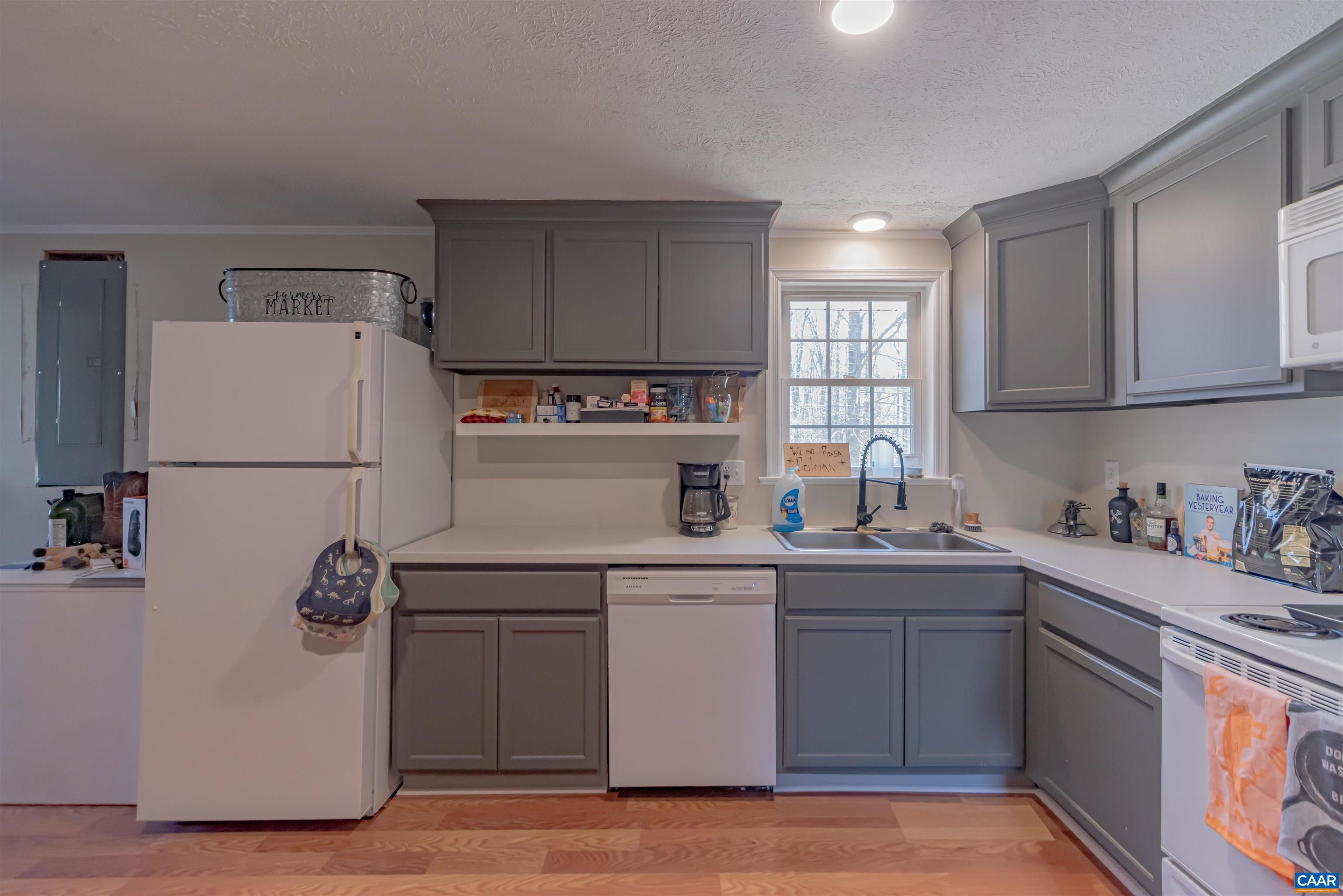 950 Apple Grove Road Mineral, VA 23117 - Photo 10 of 37 a kitchen with a sink a refrigerator and cabinets