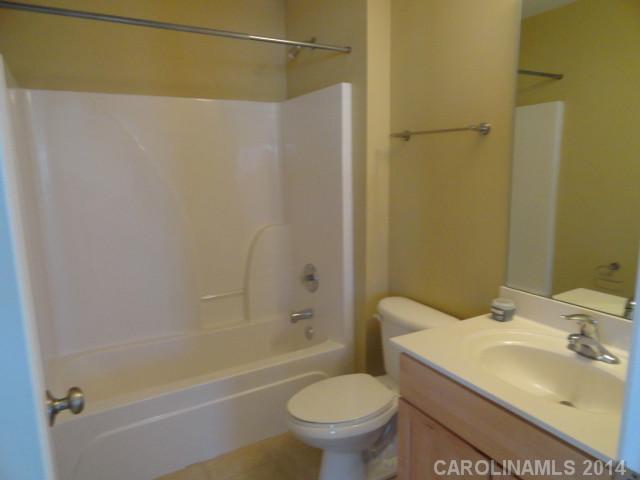 608 Raphael Place, Unit 608 Charlotte, NC 28205 - Photo 12 of 14 a bathroom with a sink toilet and shower