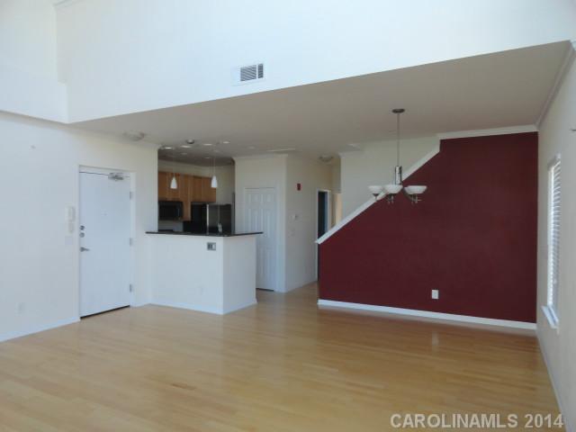 608 Raphael Place, Unit 608 Charlotte, NC 28205 - Photo 3 of 14 a view of an empty room with wooden floor