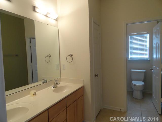 608 Raphael Place, Unit 608 Charlotte, NC 28205 - Photo 7 of 14 a bathroom with a sink a toilet and shower