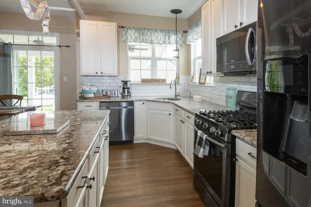 a kitchen with stainless steel appliances granite countertop counter space a sink and a window