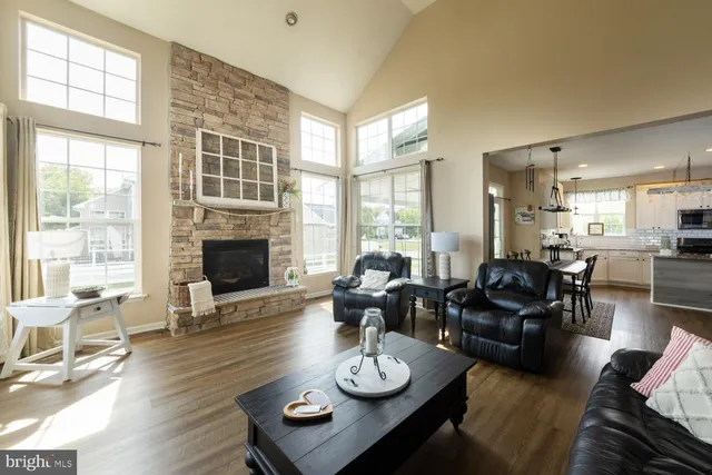 a living room with furniture fireplace and a table