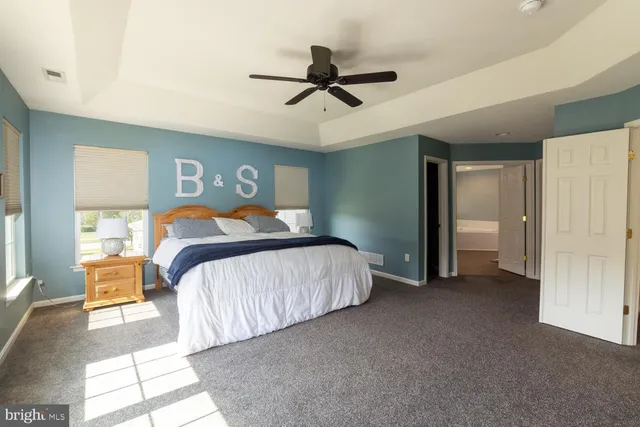 a bedroom with a bed and a ceiling fan
