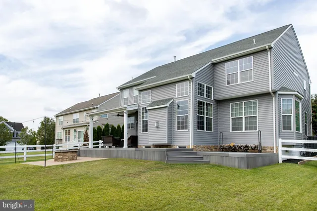 front view of a house with swimming pool having outdoor seating