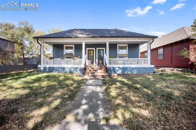 a front view of house with yard outdoor seating and barbeque oven