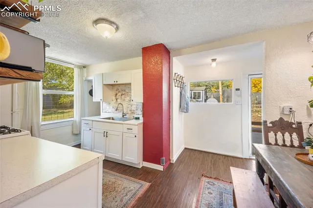 a spacious bathroom with a granite countertop sink a mirror and a bathtub