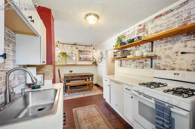 a kitchen with stainless steel appliances a stove a sink and a refrigerator