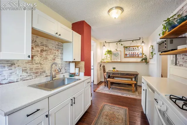 a kitchen with a sink stove and cabinets