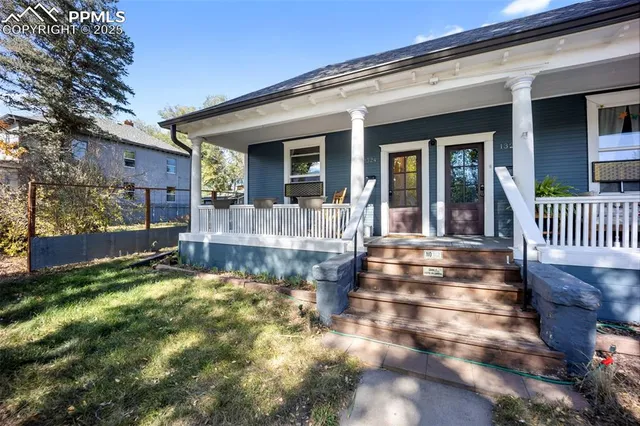 a view of a house with backyard porch and sitting area