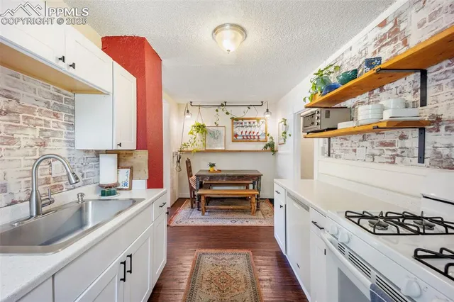 a kitchen with stainless steel appliances a stove a sink and a refrigerator
