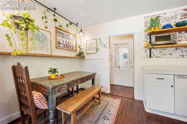 a dining room with furniture and wooden floor