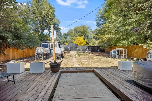 a view of a patio with chairs and potted plants