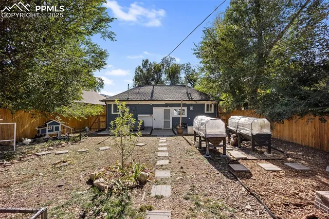 a backyard of a house with table and chairs