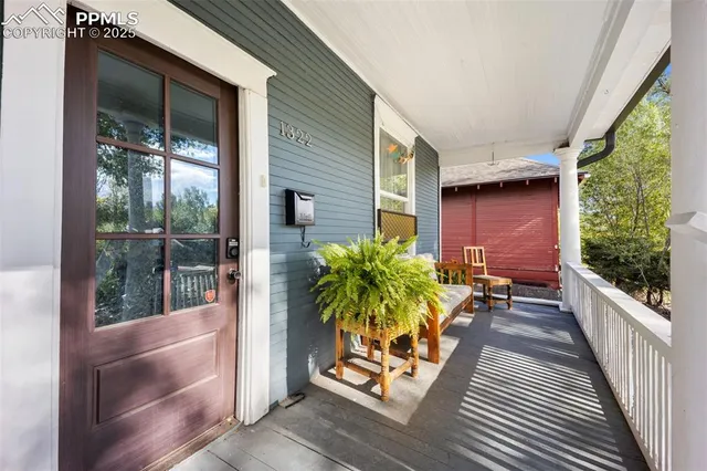 a porch with seating space and hardwood floor