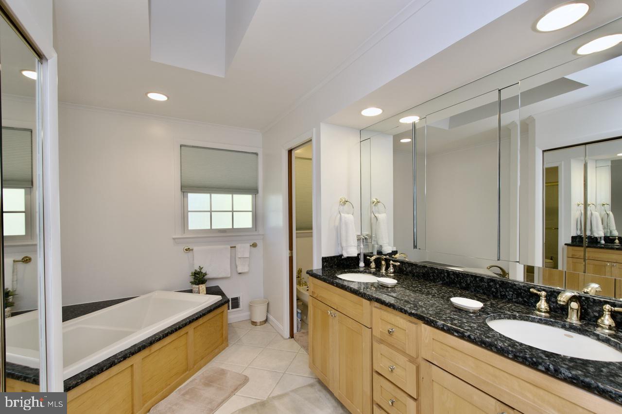 6613 Kerns Road Falls Church, VA 22042 - Photo 19 of 48 a spacious bathroom with a granite countertop tub and a sink
