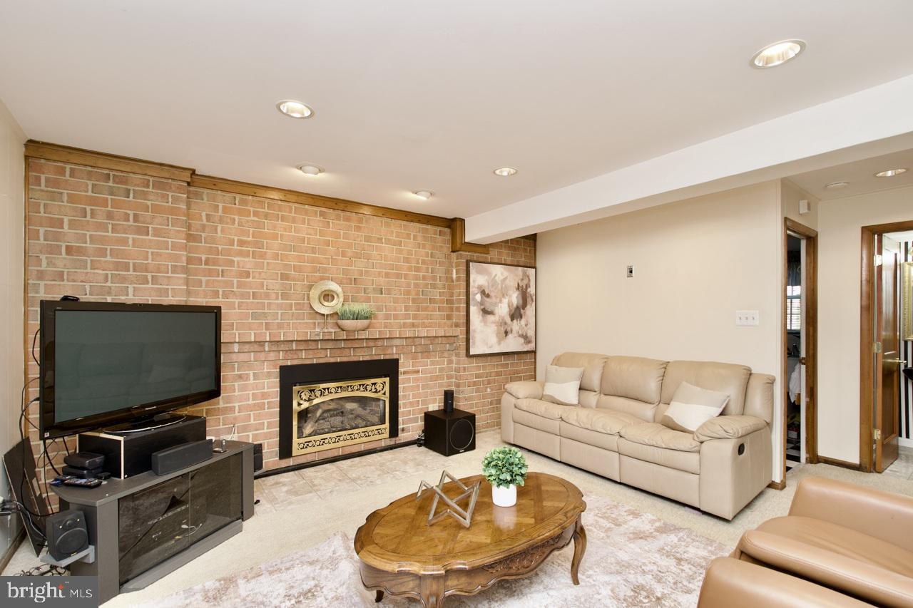 6613 Kerns Road Falls Church, VA 22042 - Photo 32 of 48 a living room with furniture a flat screen tv and a fireplace