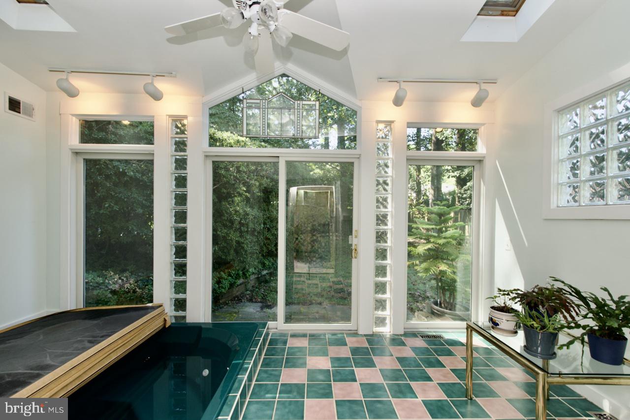 6613 Kerns Road Falls Church, VA 22042 - Photo 33 of 48 a living room with black furniture and a floor to ceiling window