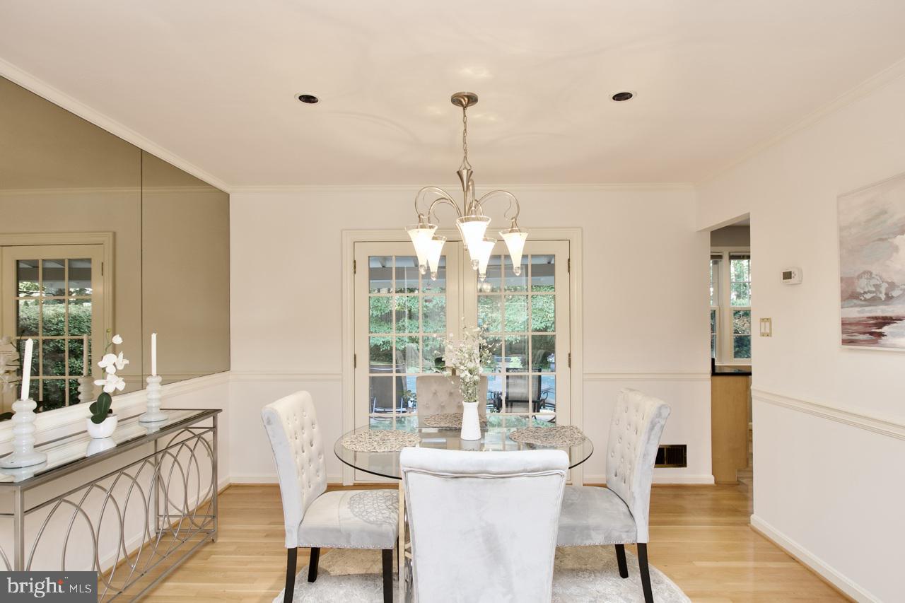 6613 Kerns Road Falls Church, VA 22042 - Photo 7 of 48 a living room with furniture a dining table and a chandelier
