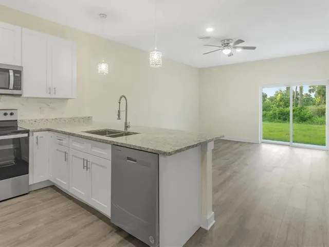 a kitchen with sink cabinets and wooden floor