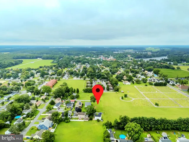 an aerial view of residential houses with outdoor space and swimming pool