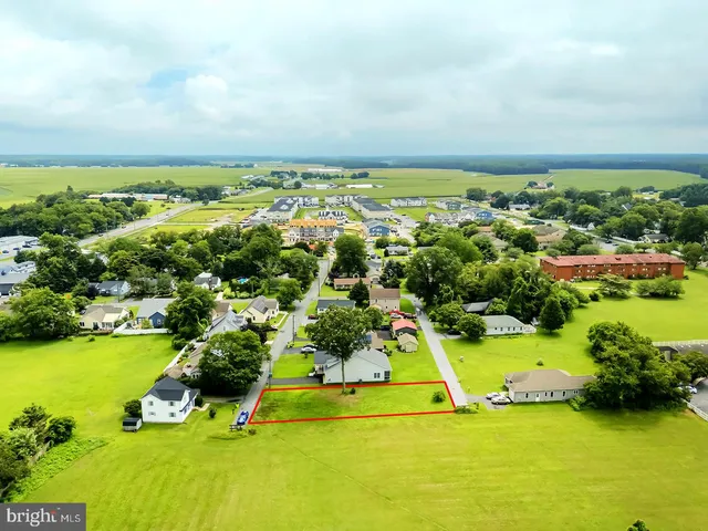an aerial view of a houses with a yard