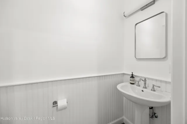 a bathroom with a sink a mirror and vanity