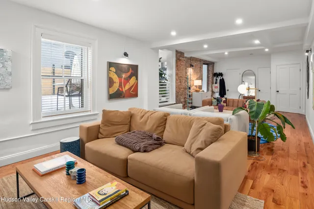 a living room with furniture cabinets and a window