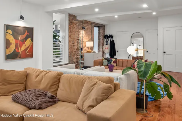 a living room with furniture flowerpot and window
