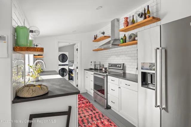 a kitchen with stainless steel appliances granite countertop a sink and cabinets