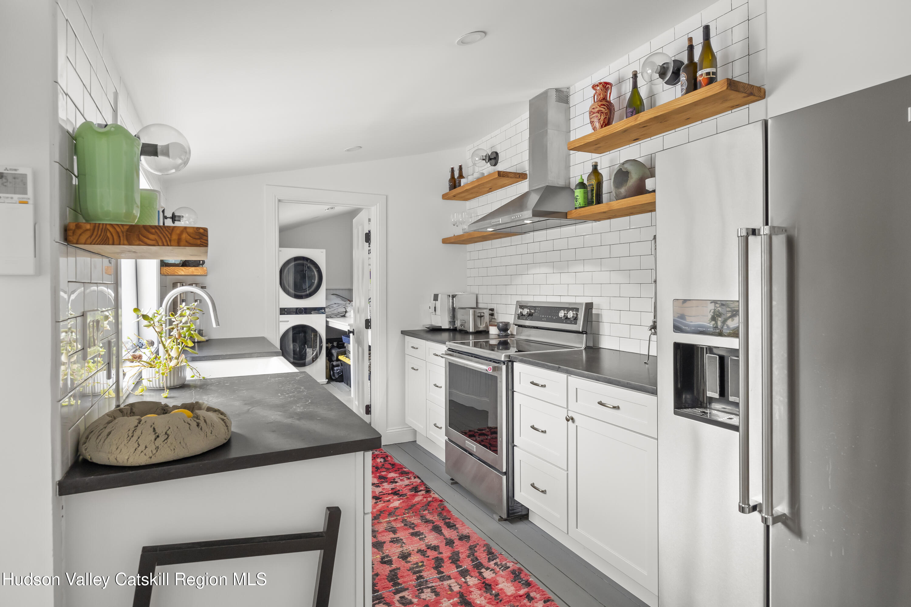 417 Warren Street, Unit A Hudson, NY 12534 - Photo 7 of 19 a kitchen with stainless steel appliances granite countertop a sink and cabinets