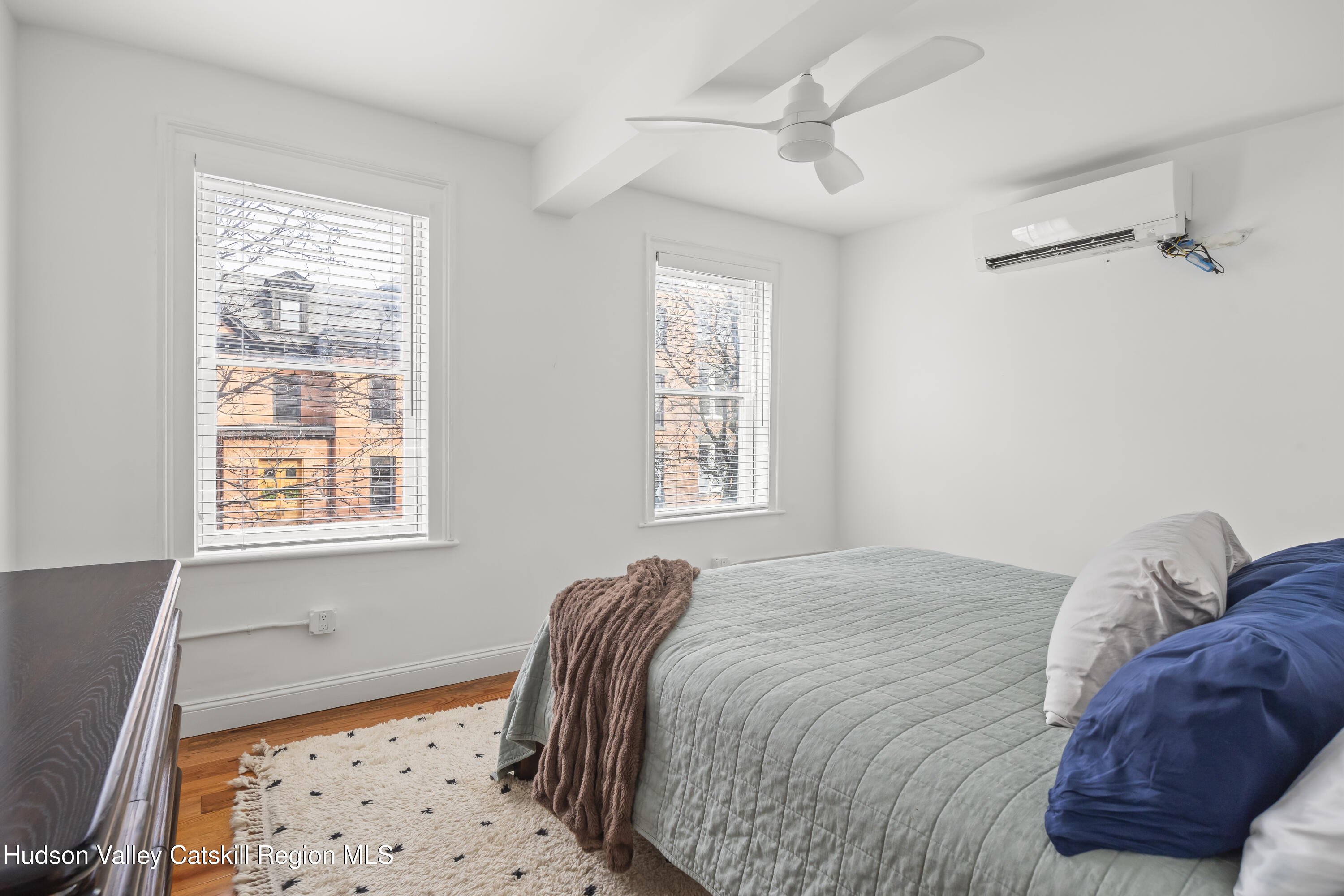 417 Warren Street, Unit A Hudson, NY 12534 - Photo 9 of 19 a bedroom with a bed and a window with chair