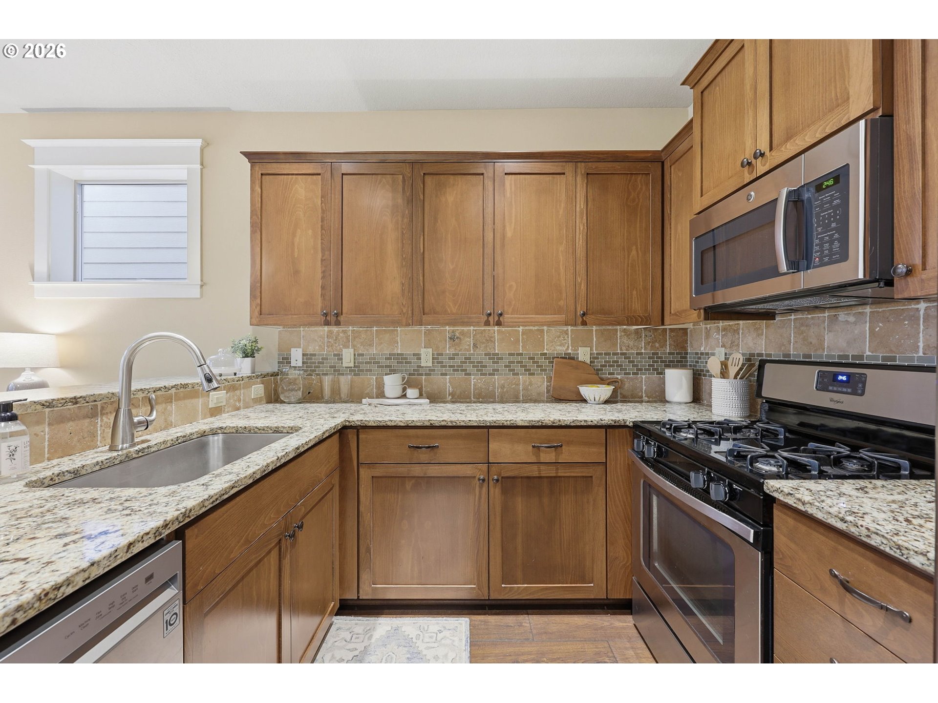 11033 Southwest Legacy Oak Way Portland, OR 97223 - Photo 11 of 47 a kitchen with stainless steel appliances granite countertop a sink stove and microwave