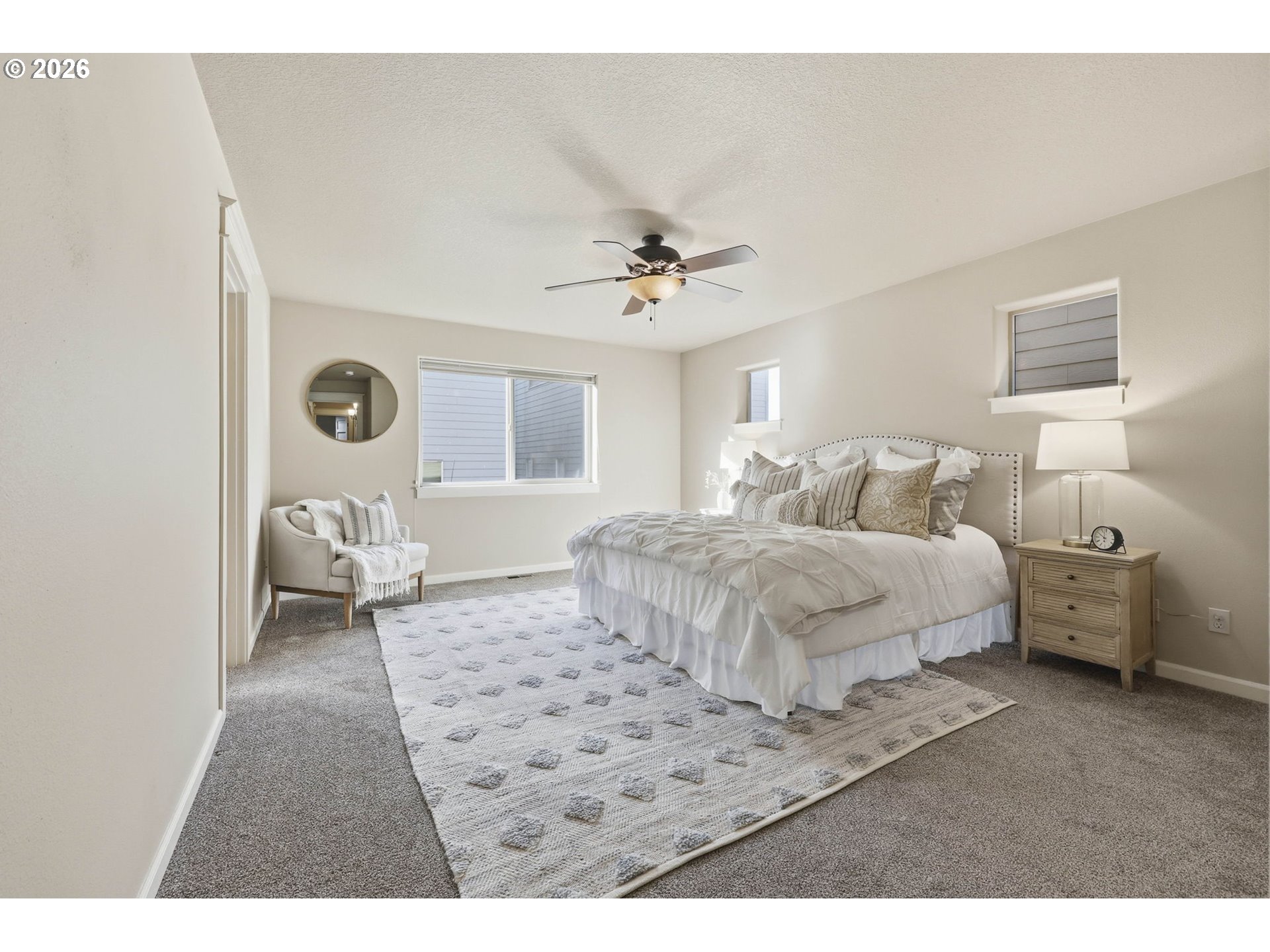11033 Southwest Legacy Oak Way Portland, OR 97223 - Photo 16 of 47 a bedroom with a large bed and a chandelier